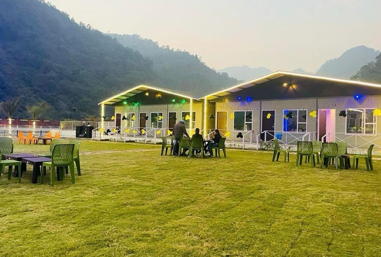 Guests relaxing on lawn at riverside stay in Rishikesh