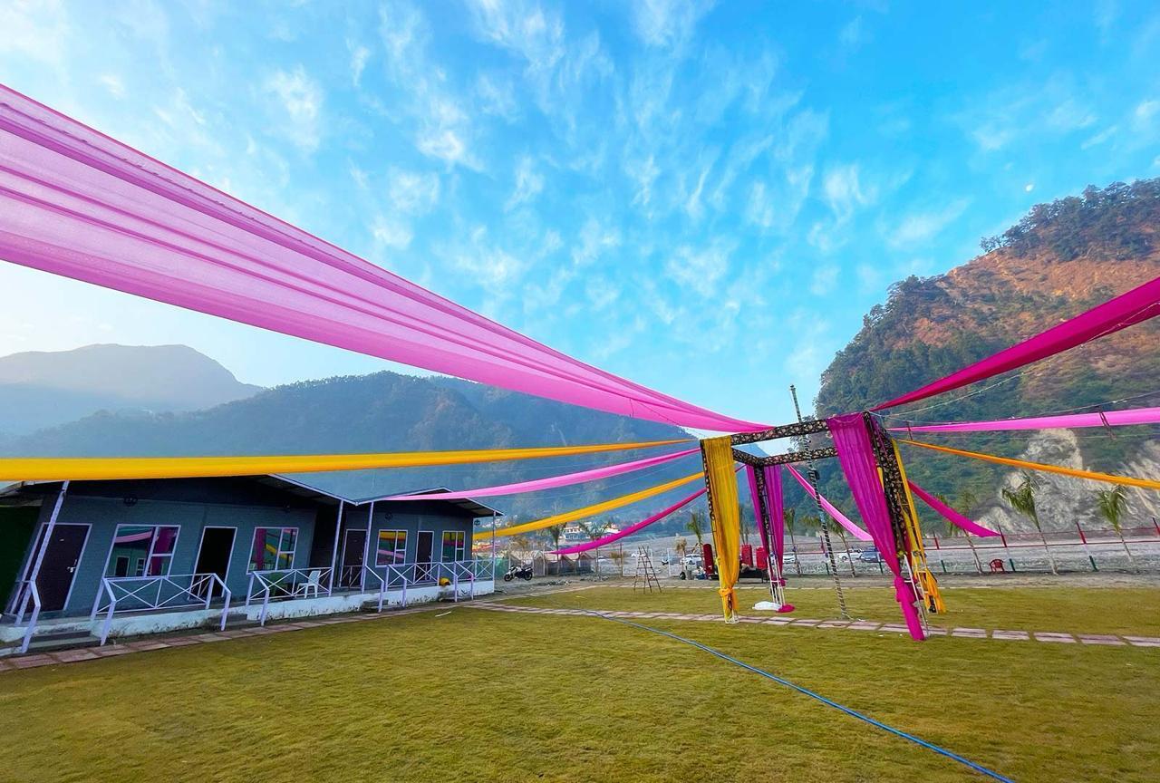 Outdoor event setup at riverside resort in Rishikesh with colorful décor